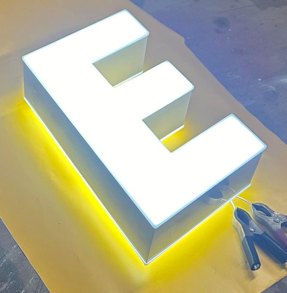 Illuminated 3D letter E with tools