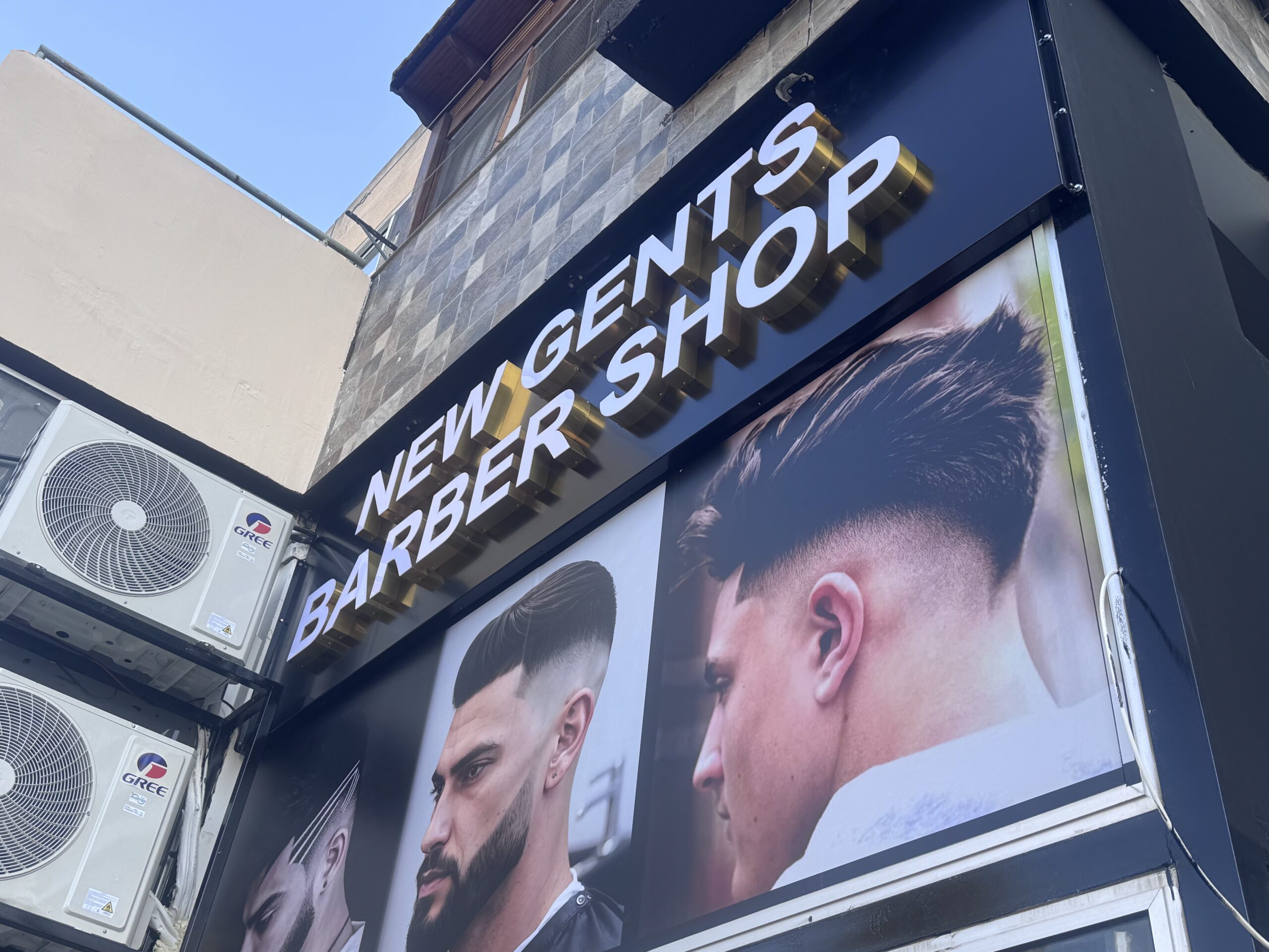 3D sign with golden mirror sides on a barber shop in Larnaca.