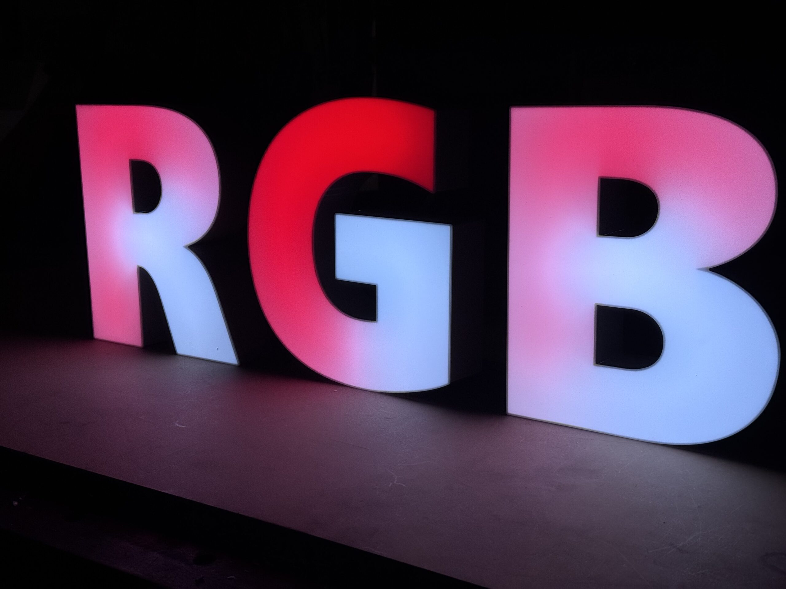 Illuminated RGB 3D letters displaying colorful gradient effects