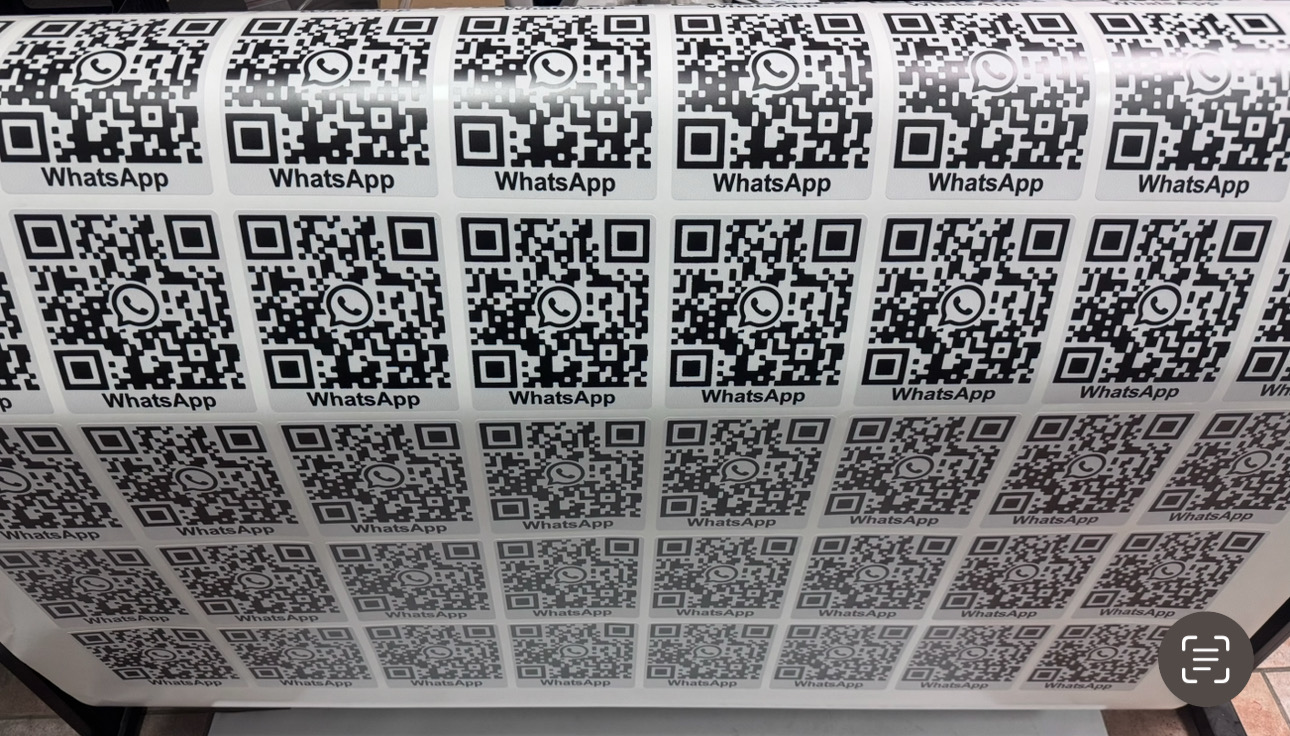 Printed sheets of custom QR codes for WhatsApp messaging.